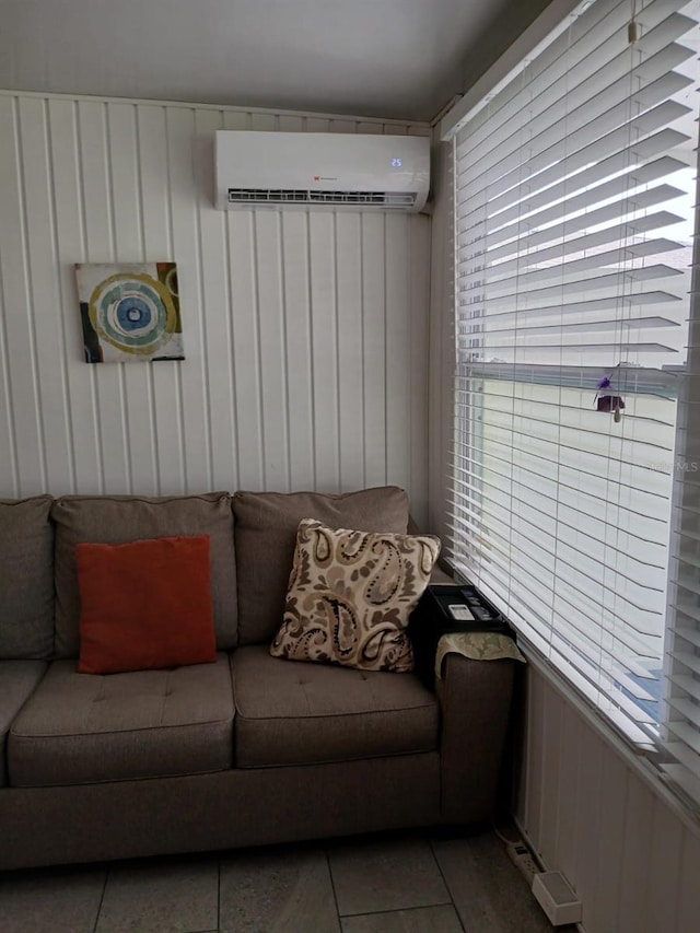 living room with tile patterned floors and a wall mounted AC