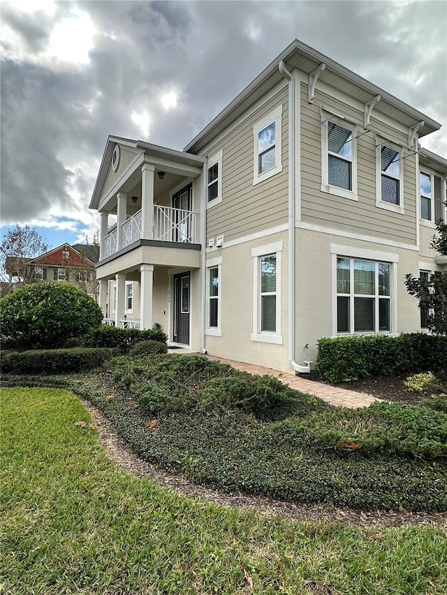 back of property with a balcony