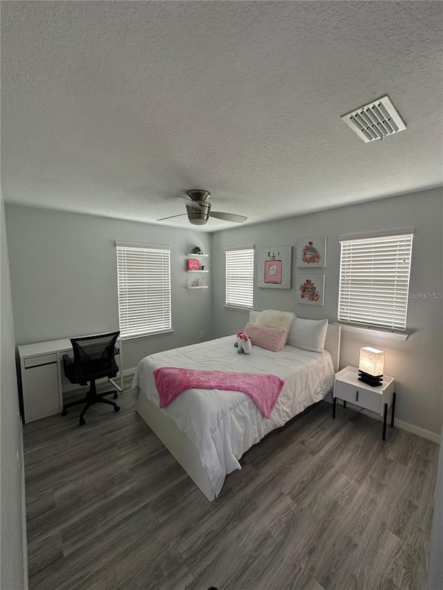 bedroom with ceiling fan and dark wood-type flooring