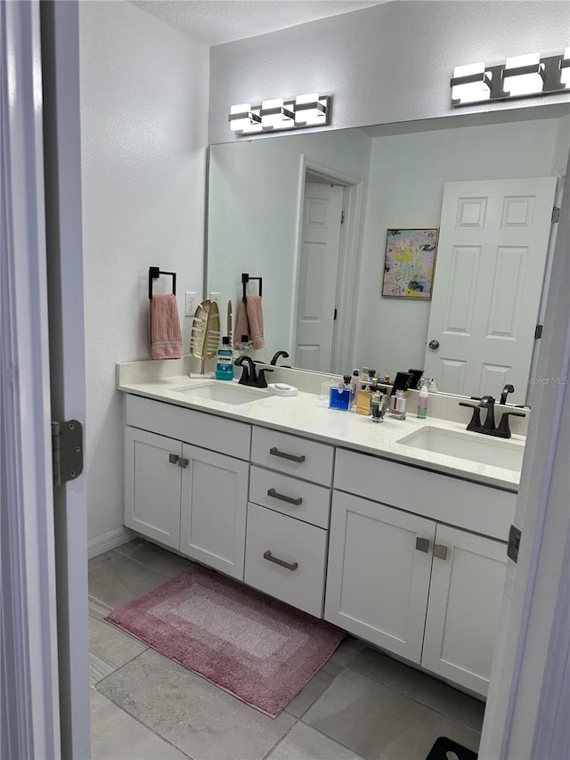 bathroom with tile patterned floors and vanity