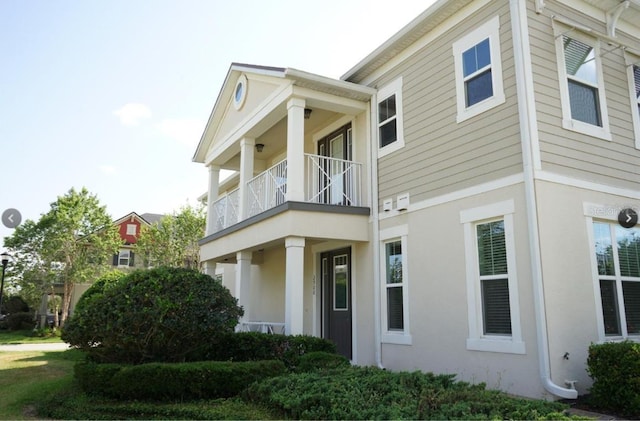 view of side of property featuring a balcony