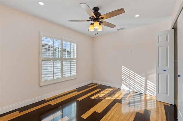 spare room featuring ceiling fan and wood-type flooring