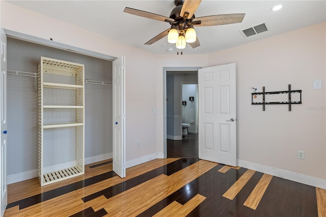 unfurnished bedroom with hardwood / wood-style flooring, ceiling fan, and a closet