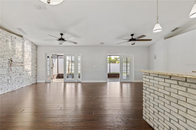 unfurnished living room featuring french doors and dark wood-type flooring