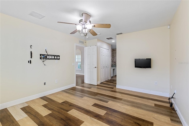 empty room with wood-type flooring and ceiling fan