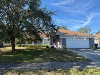 view of front of house with a garage and a front lawn