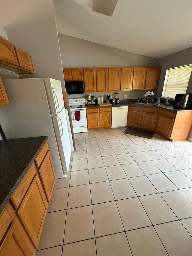 kitchen with white appliances, light tile patterned floors, and vaulted ceiling