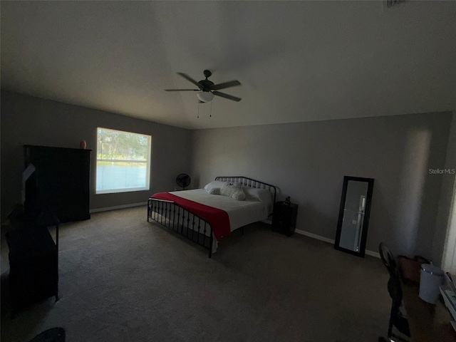 bedroom with ceiling fan, carpet floors, and lofted ceiling