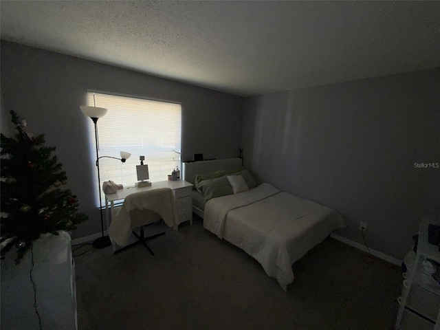 bedroom with carpet and a textured ceiling