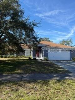 obstructed view of property with a front yard