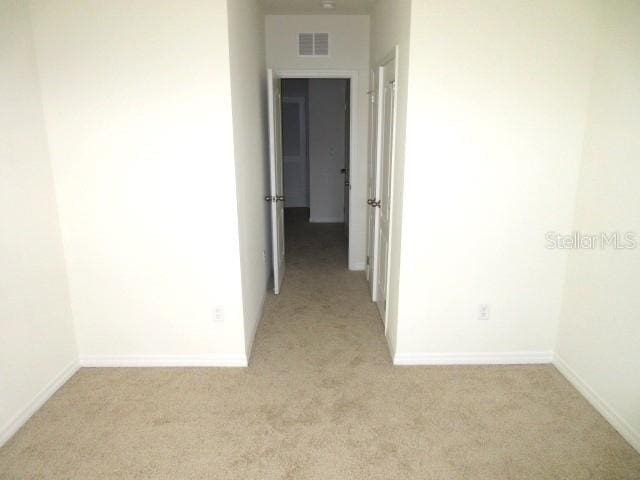 corridor with light colored carpet