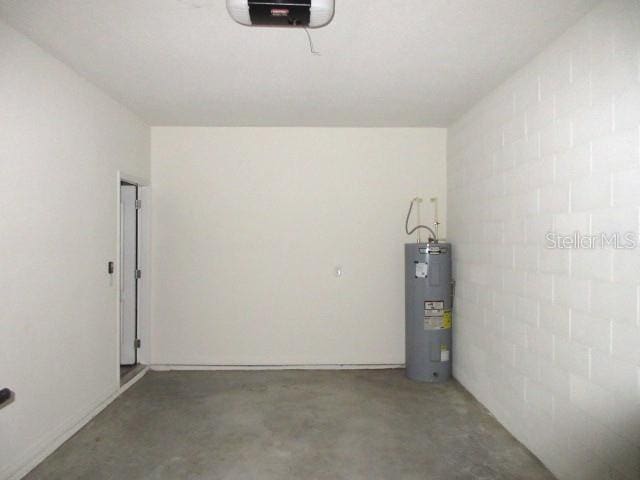 garage featuring a garage door opener and water heater