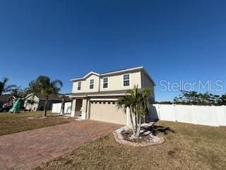 view of front facade with a garage and a front lawn