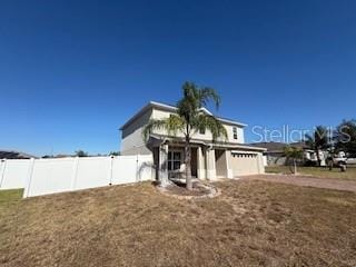 view of front facade featuring a garage and a front yard