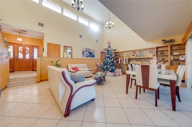 living room with a chandelier, a high ceiling, and light tile patterned flooring