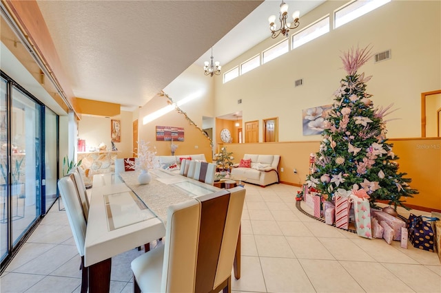 dining space featuring a wealth of natural light, light tile patterned floors, and a notable chandelier