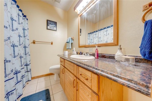 bathroom with toilet, vanity, tile patterned floors, and a shower with shower curtain