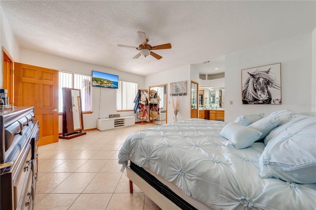 bedroom featuring a textured ceiling, ceiling fan, a spacious closet, connected bathroom, and a closet