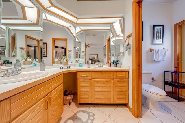 bathroom featuring tile patterned flooring, vaulted ceiling, toilet, vanity, and a shower with shower door