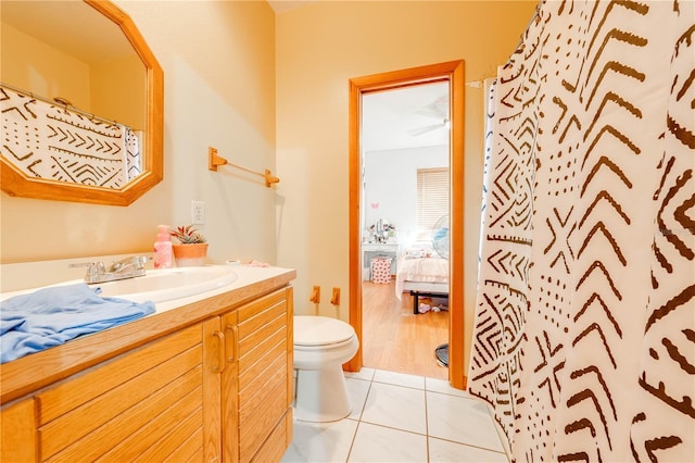 bathroom featuring tile patterned flooring, vanity, toilet, and a shower with shower curtain