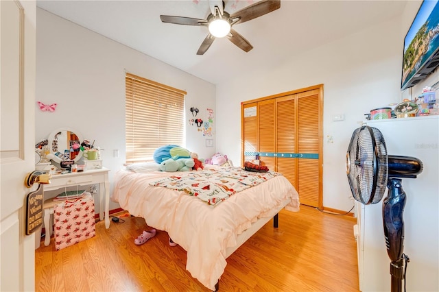 bedroom with ceiling fan, a closet, and hardwood / wood-style floors