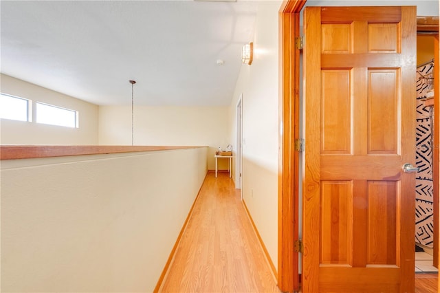 hallway with light hardwood / wood-style flooring