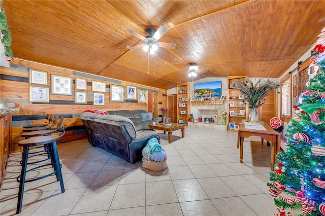 tiled living room featuring wooden walls, vaulted ceiling, built in features, and wooden ceiling