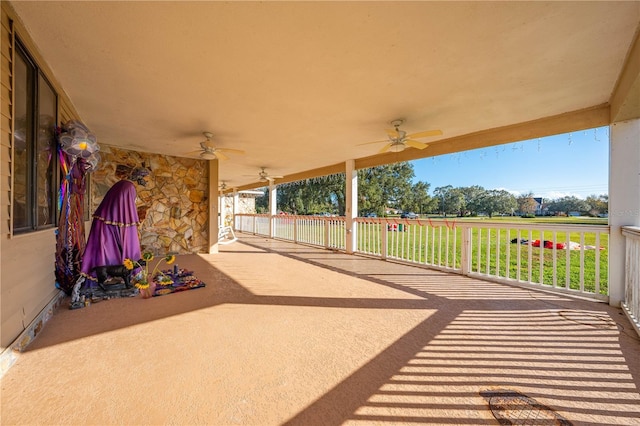 view of patio / terrace with ceiling fan, a rural view, and covered porch