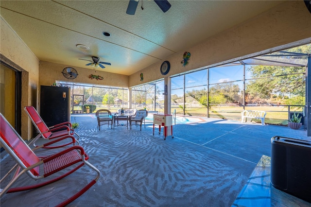 view of patio / terrace with glass enclosure and ceiling fan