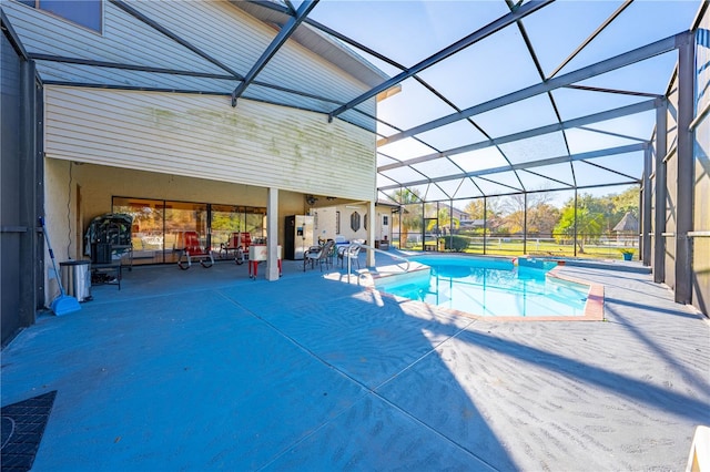 view of swimming pool featuring a patio area and a lanai