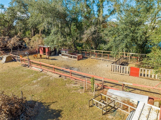 view of yard featuring a rural view and a shed