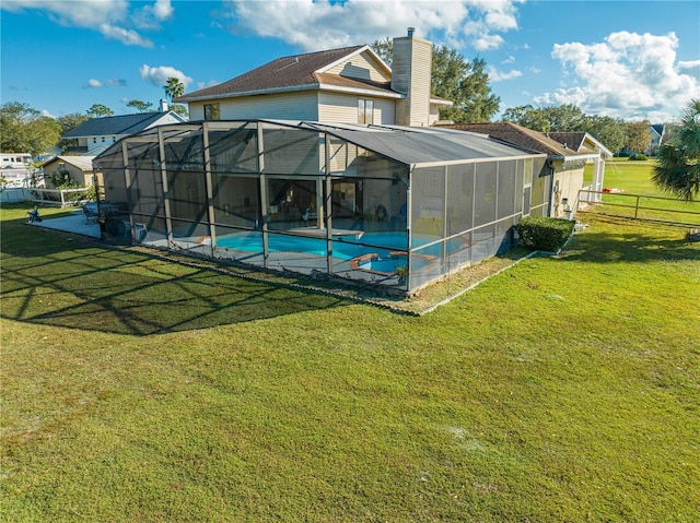 exterior space featuring glass enclosure and a lawn