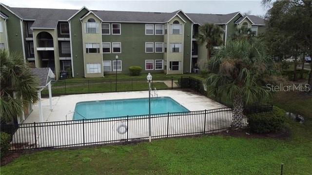 view of pool with a patio area and a yard