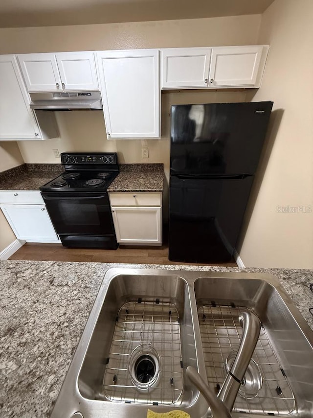 kitchen with stone counters, sink, white cabinetry, and black appliances