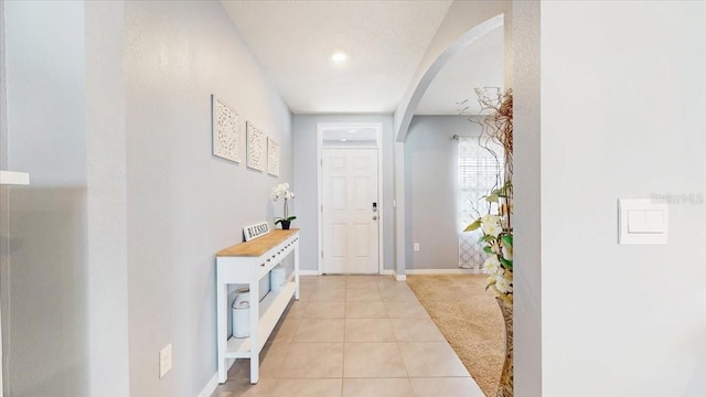 hallway featuring light tile patterned flooring