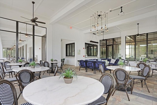 interior space with ceiling fan and beamed ceiling