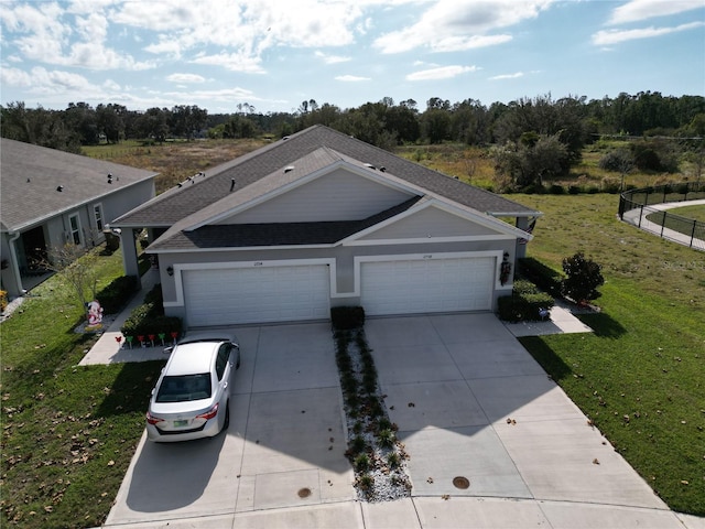 view of front of home featuring a front yard and a garage