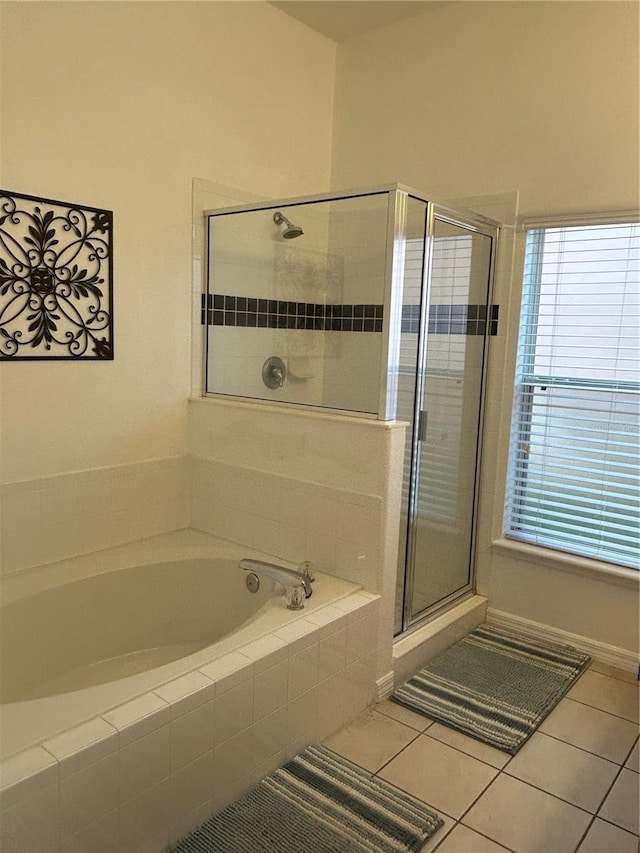 bathroom with shower with separate bathtub and tile patterned floors