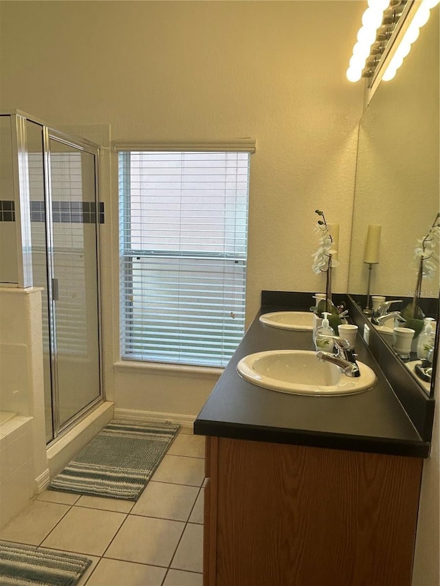 bathroom featuring tile patterned flooring, vanity, and a shower with shower door