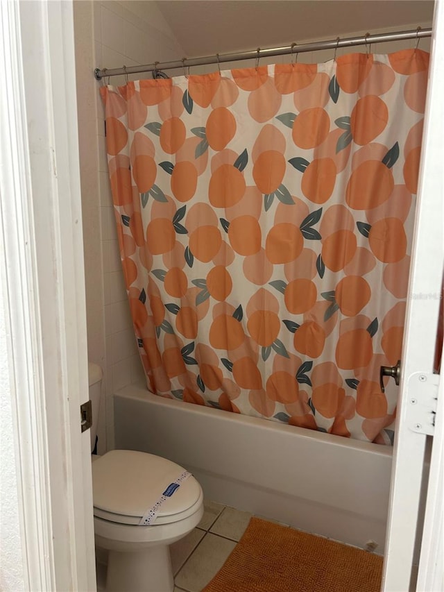 bathroom featuring tile patterned flooring, shower / bath combo, and toilet