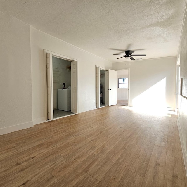 empty room featuring crown molding, hardwood / wood-style flooring, ceiling fan, a textured ceiling, and washer / clothes dryer