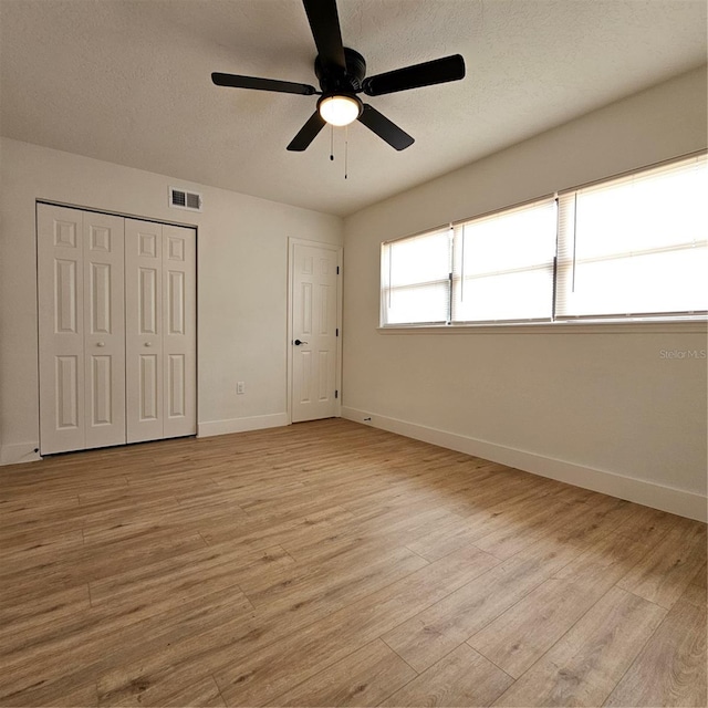 unfurnished bedroom with light hardwood / wood-style flooring and ceiling fan