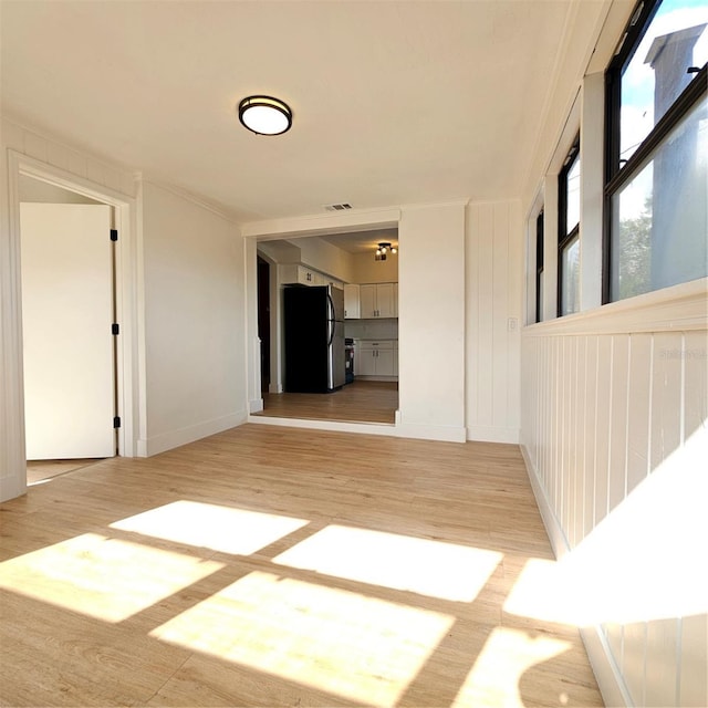 hallway with light hardwood / wood-style flooring