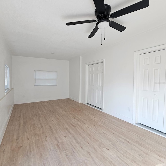 empty room featuring light wood-type flooring and ceiling fan