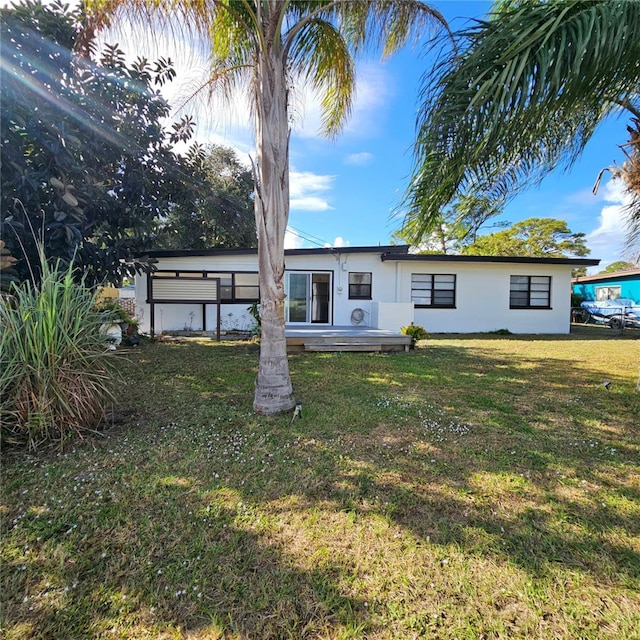 rear view of property with a lawn