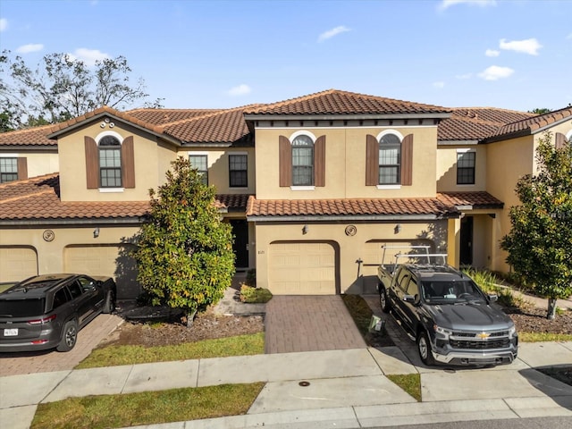 mediterranean / spanish home with a garage