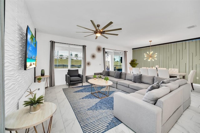 living room featuring ceiling fan with notable chandelier