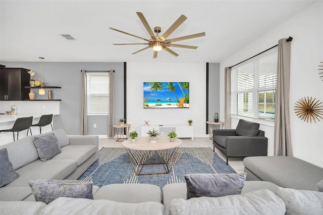 carpeted living room with ceiling fan