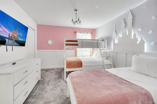 carpeted bedroom with a chandelier