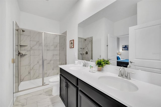 bathroom with vanity, an enclosed shower, and toilet